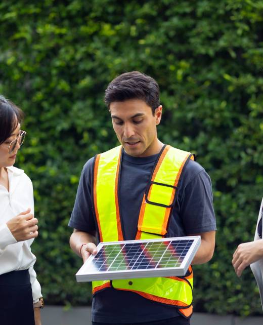 clean and green alternative energy concept. business woman and Office building owner and energy engineer plan a project to build a solar panel for the building under construction