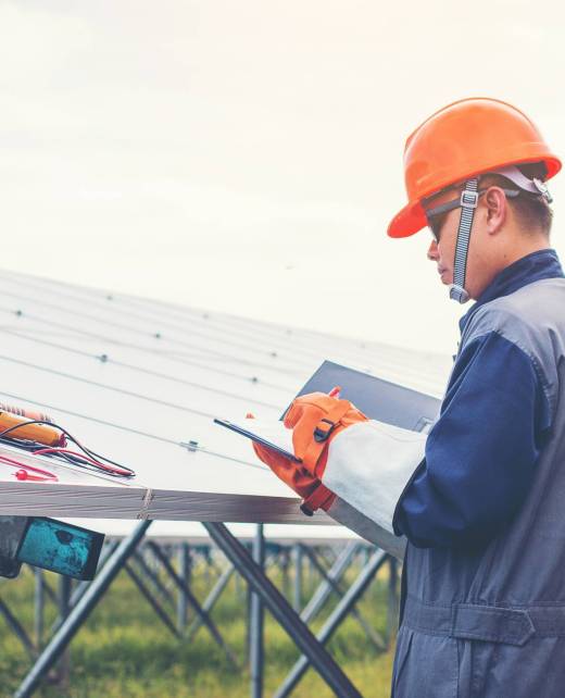 engineers operating and check generating power of solar power plant on solar rooftop; technician in industry uniform on level of job description at industrial